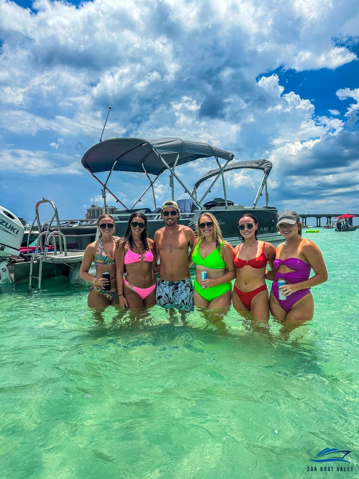 Guests wading at the Crab Island sandbar beside their pontoon