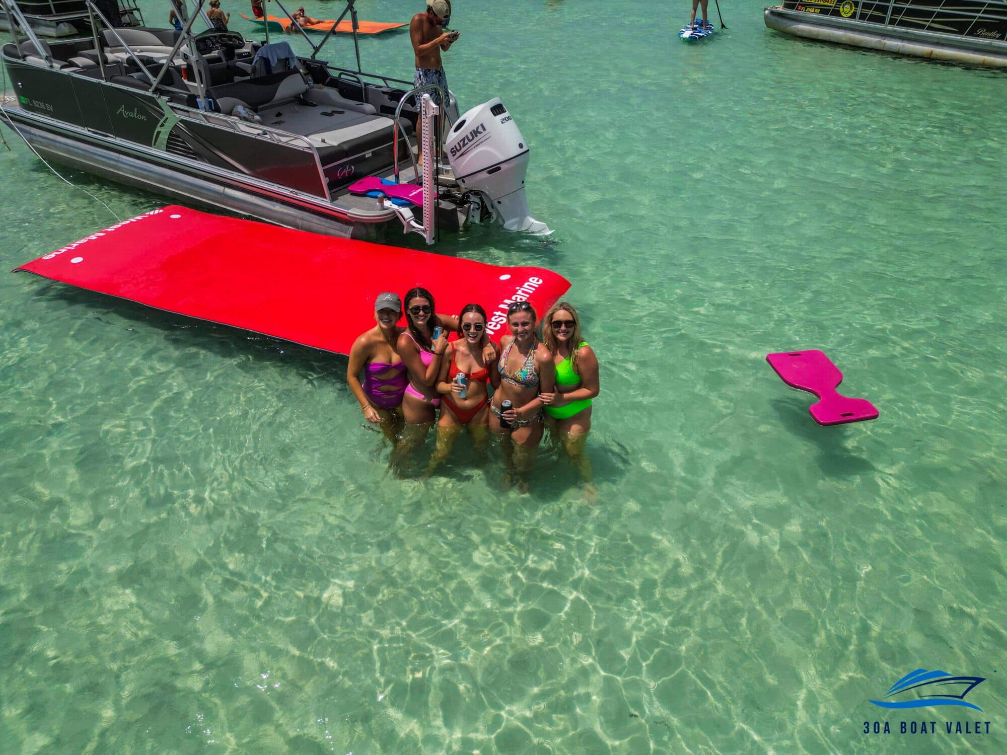 Group in the water beside the pontoon